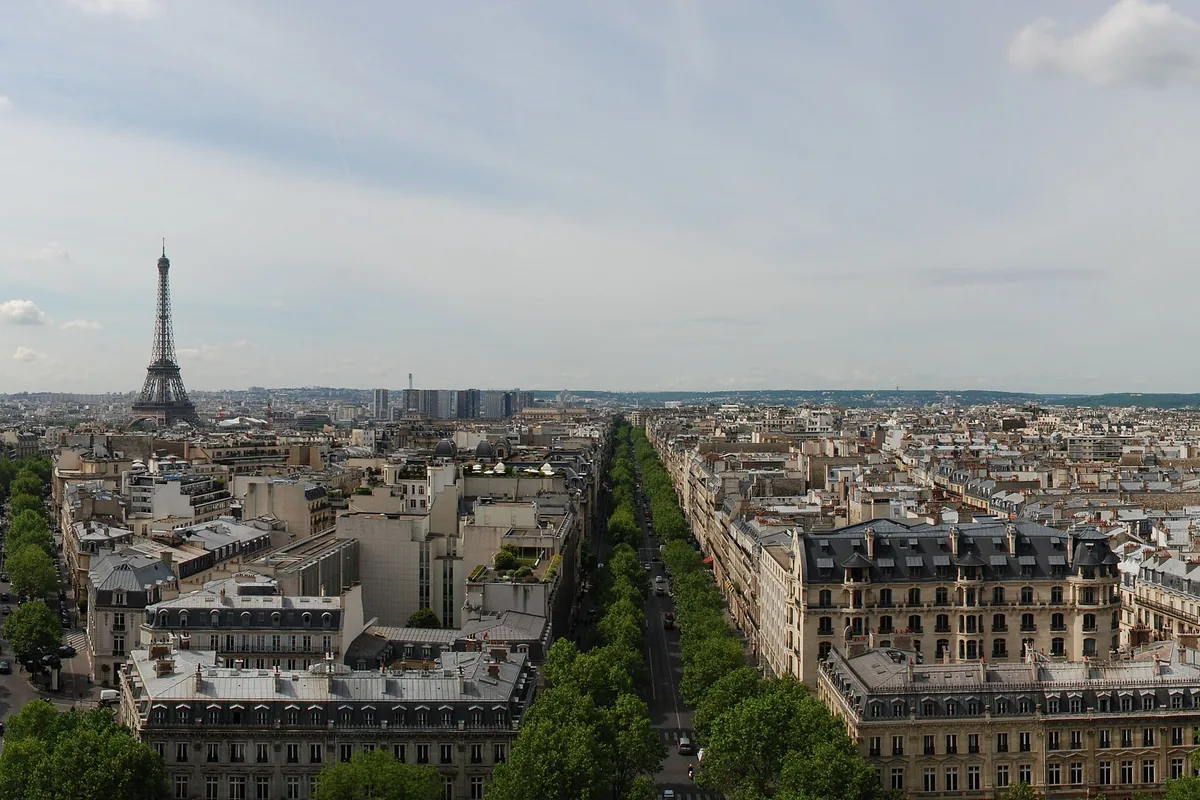 Panoramic view of Paris from the Arc de Triomphe rooftop terrace, with the Eiffel Tower in the distance